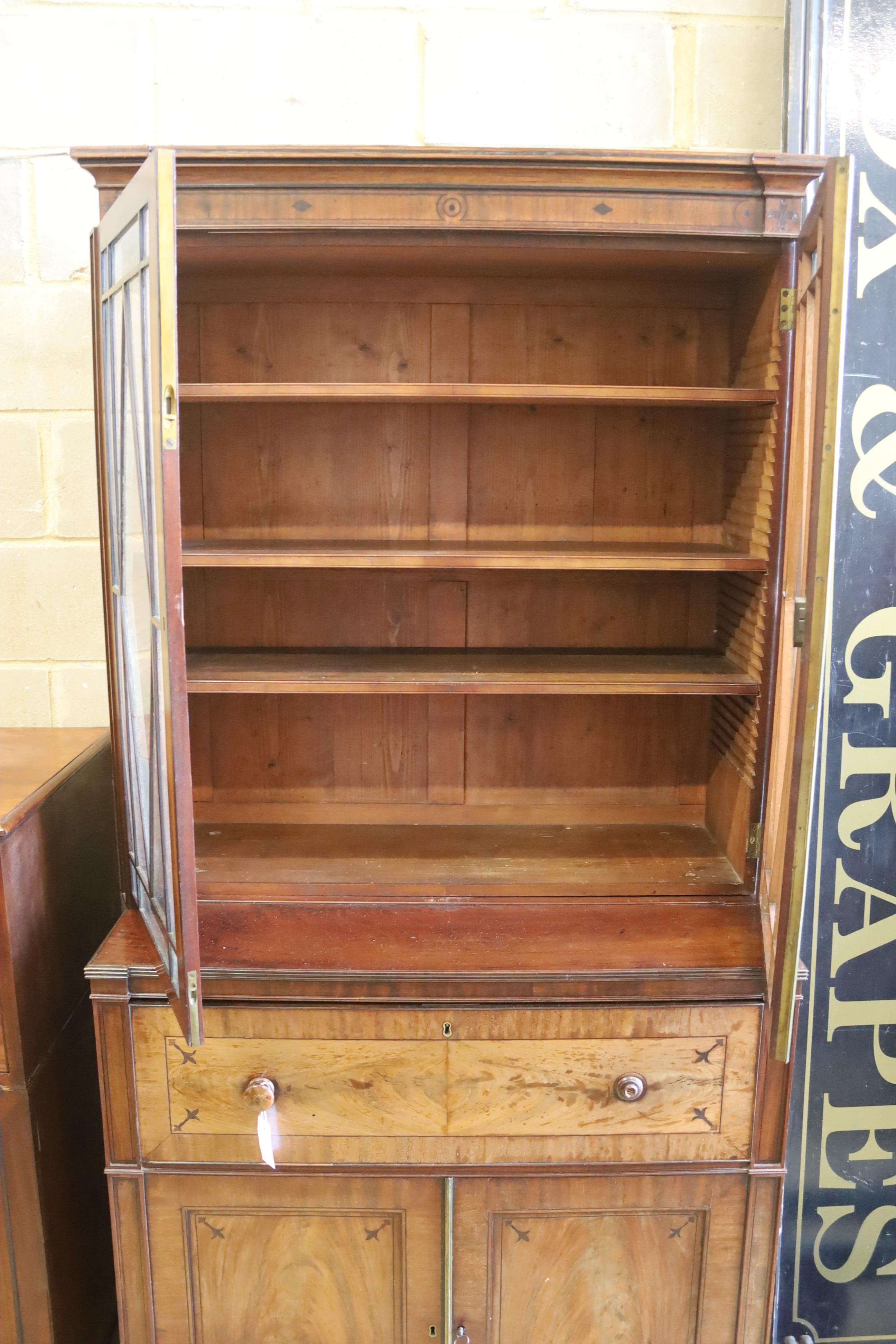 A Regency mahogany secretaire bookcase on lion paws feet, length 100cm, depth 56cm, height 216cm